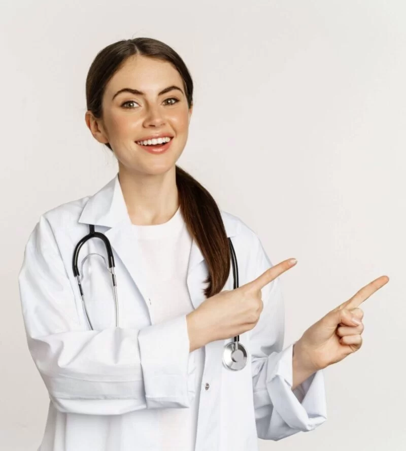 portrait-smiling-young-woman-doctor-healthcare-medical-worker-pointing-fingers-left-showing-clini-scaled-e1710966275825